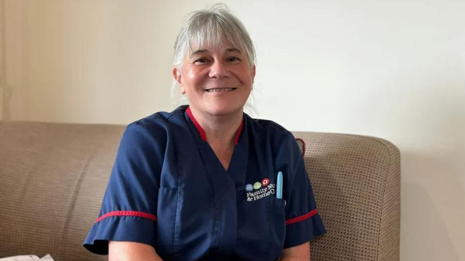 Gilly Glendewar sat in her nursing uniforms 