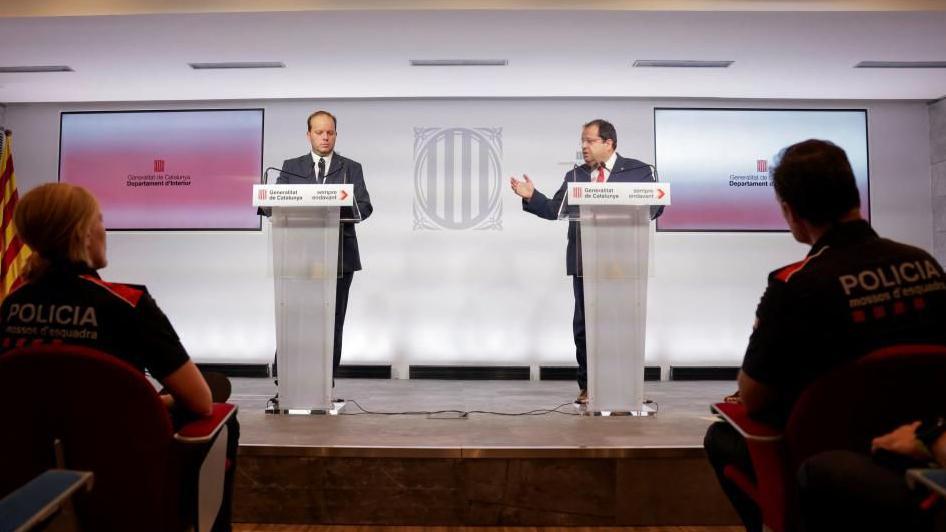 Catalan Interior Minister Joan Ignasi Elena i Garcia and Catalan police director Pere Ferrer hold a press conference, next to Mossos d'Esquadra police officers, 