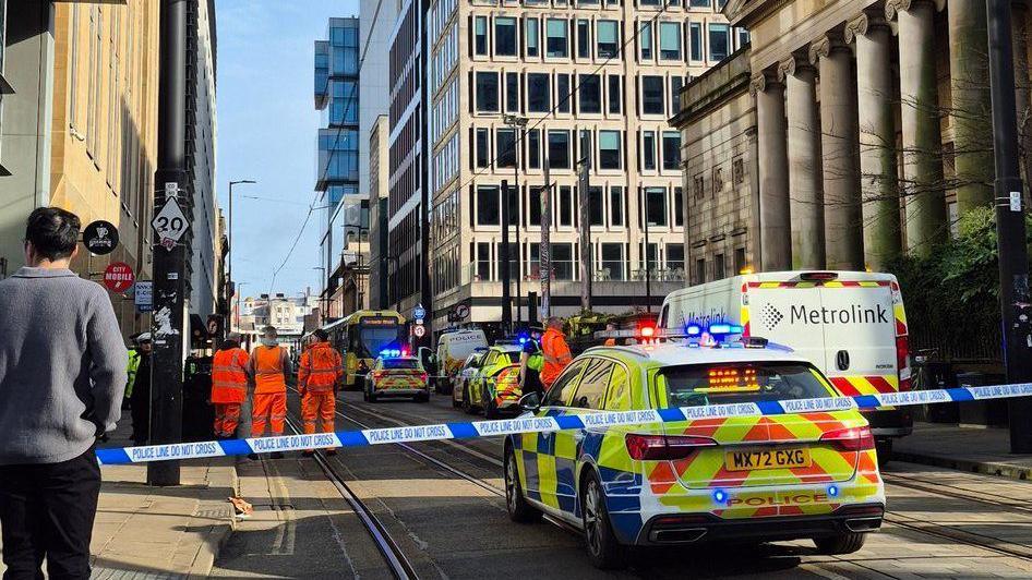 A bystander watches near a police cordon strapped near the art gallery and other modern office and apartment blocks