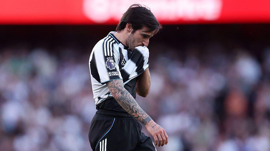 Newcastle's Sandro Tonali wipes his face with his shirt