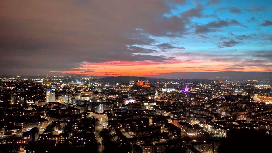 Edinburgh skyline lit up at night.