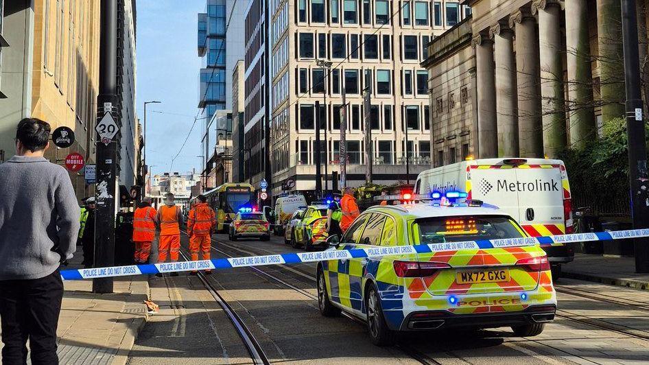 A bystander watches near a police cordon strapped near the art gallery and other modern office and apartment blocks