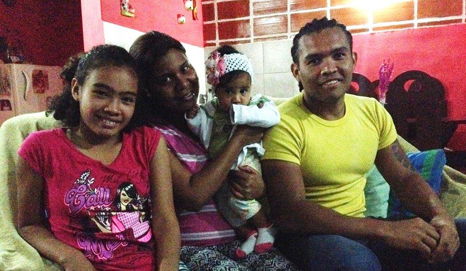 Marta Mendivil with her two children and her husband in their flat in the Santa Rosa housing estate