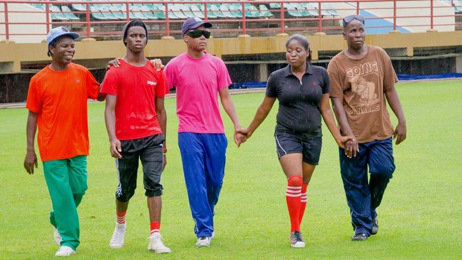 Players for Guyana's Blind Cricket Association walk back to the stands in the National Stadium