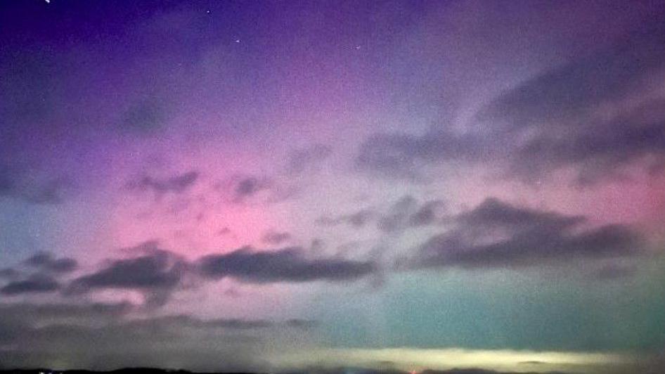 A pink and purple sky with clouds.