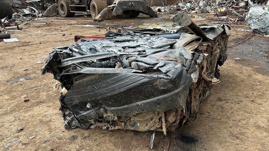 A crushed Subaru in a scrapyard 