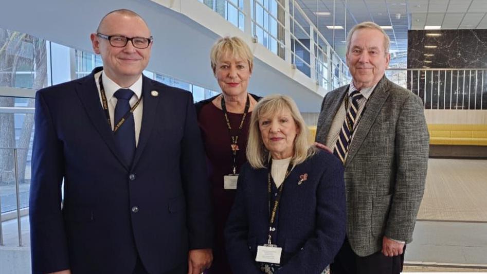 Councillors O'Connor, Thomason-Kenyon, Knight, and Parsonage standing together in the atrium at County Hall in Truro.