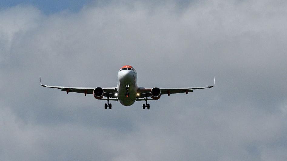 A commercial plane flying in the sky.