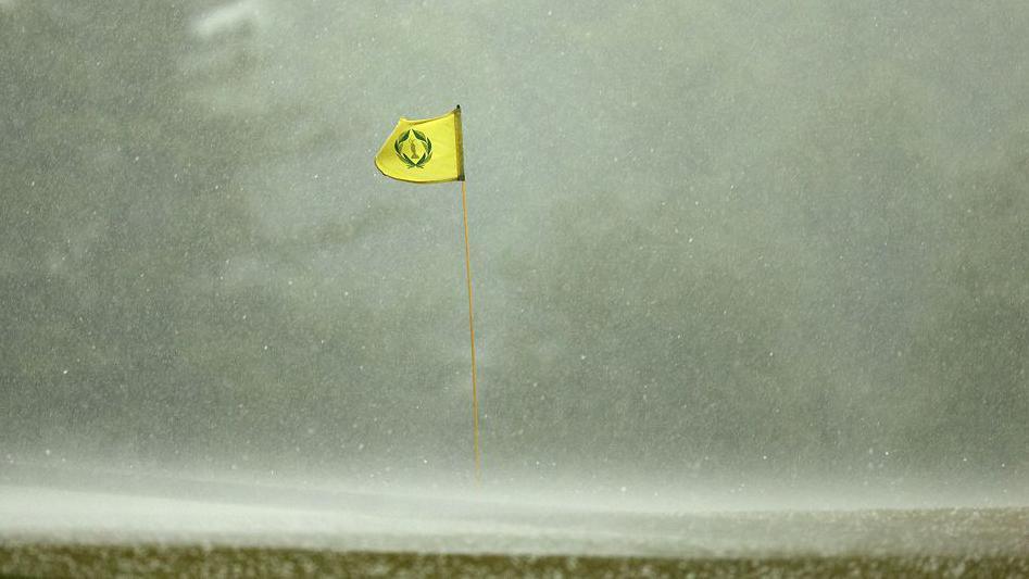 A flag billowing in the wind in heavy rain
