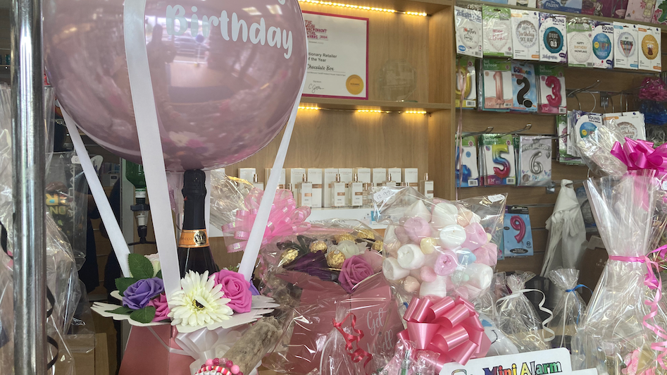 Gift hampers in a shop, with a happy birthday balloon