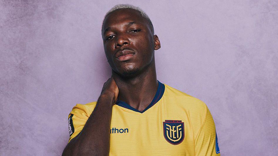 Moises Caicedo posing with his hand behind his neck for a Fifa photoshoot with Ecuador