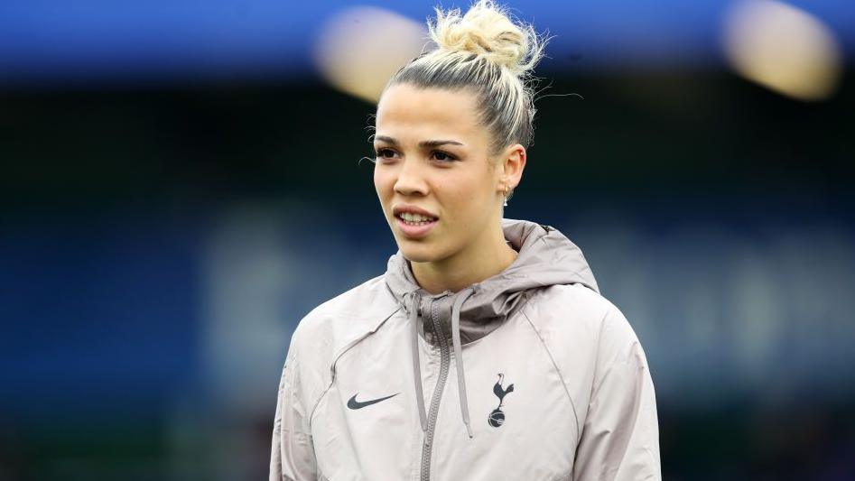 Celin Bizet looks on in a Tottenham top ahead of a game