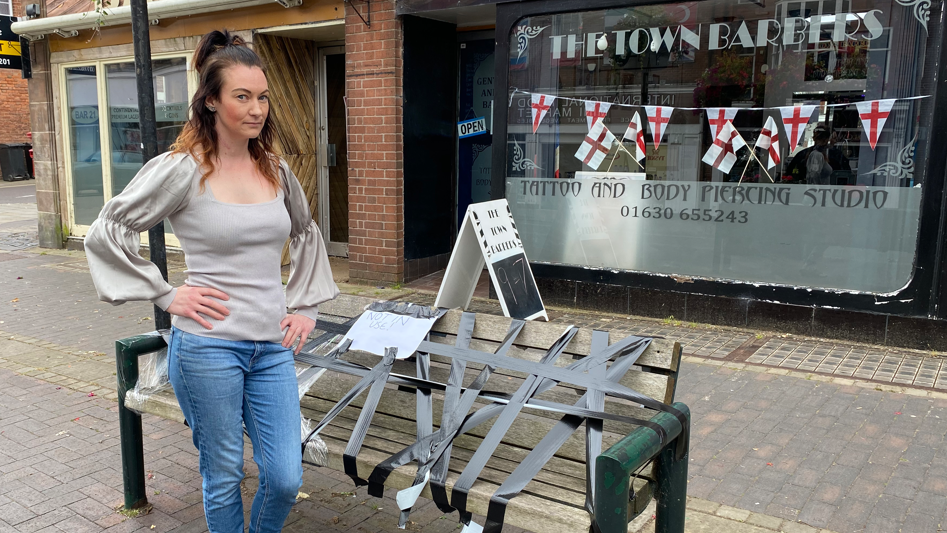 Rebecca Sutton standing in front of a taped off bench