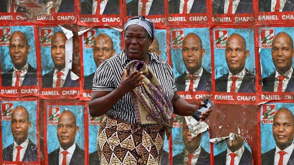 A woman reacts to tear gas in Maputo, Mozambique - Monday 21 October 2024