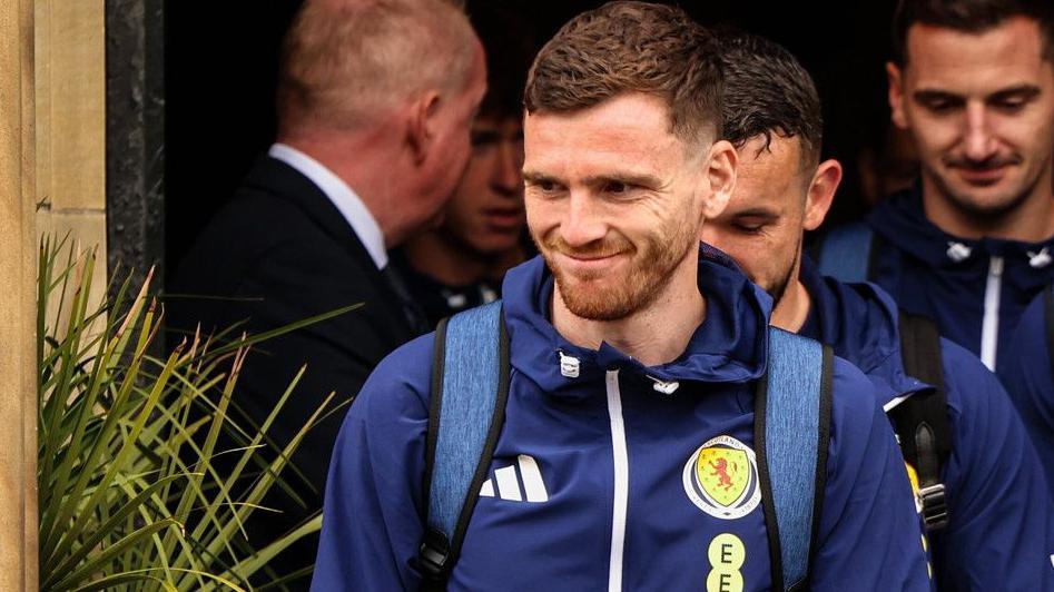 Scotland captain Andy Robertson leads the squad out of their Glasgow hotel