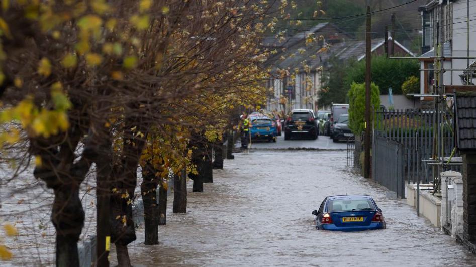 A blue Ford Mondeo car submerged in water on Sion Street on November 24, 2024 in Pontypridd, Wales