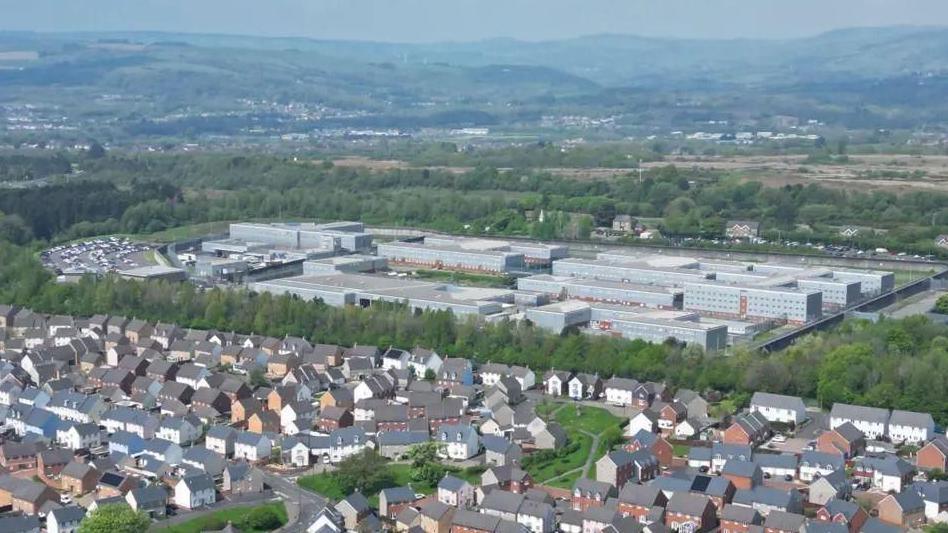 An aerial shot of HMP Parc with residential houses seen in front of it.