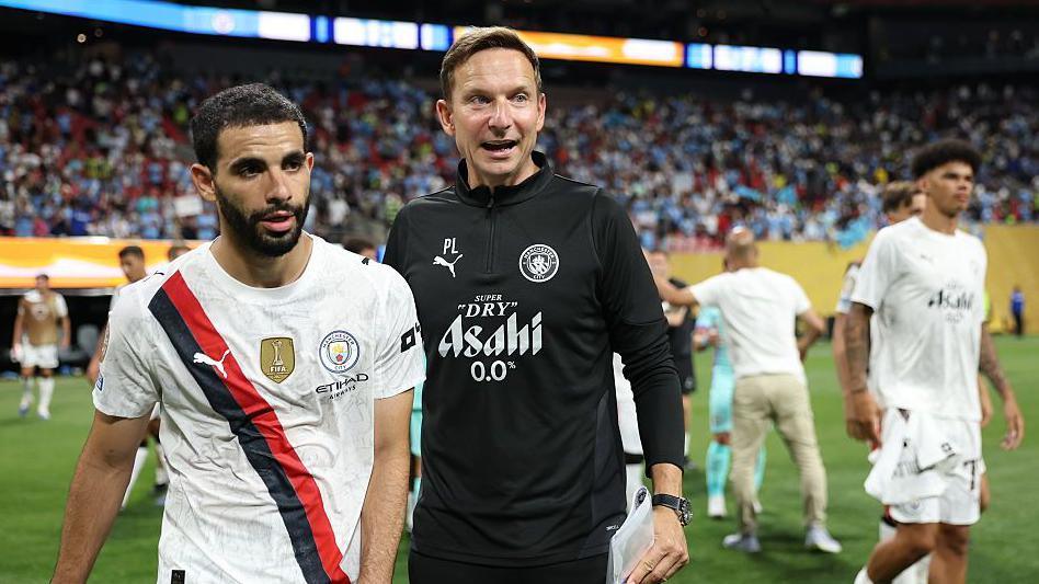 Manchester City assistant coach Pep Lijnders talks to the club's players