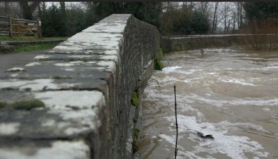 Water levels really high virtually reaching the top of a stone bridge and Barcombe