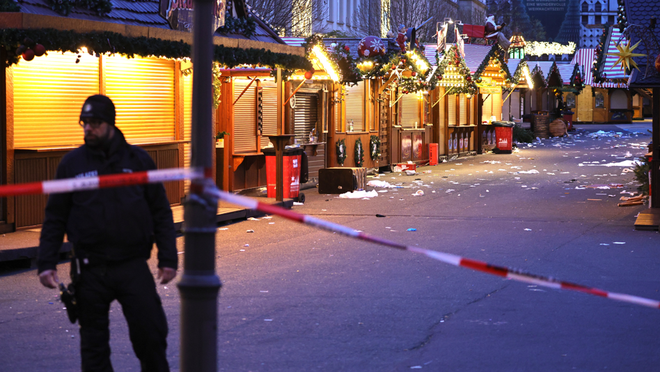 A policeman walks through the shuttered Christmas market the day after a terror attack that has left five people dead, including a small child, and over 200 injured on December 21, 2024 in Magdeburg,