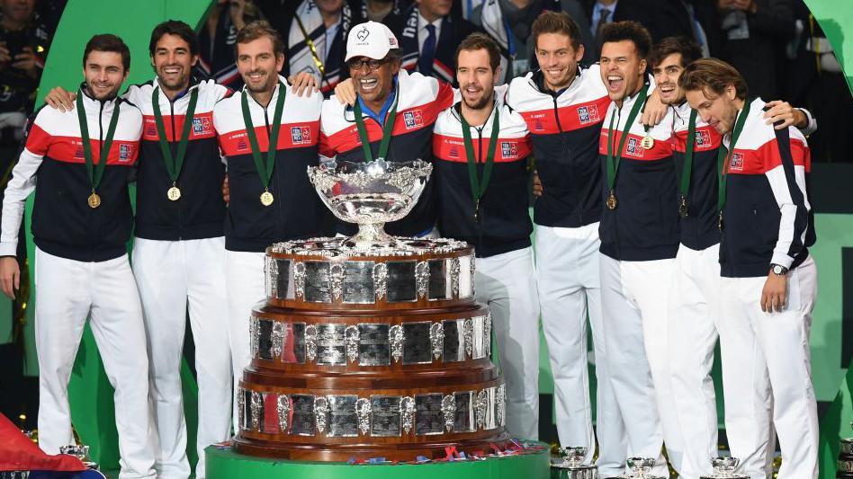 France's Gilles Simon, Jeremy Chardy, Julien Benneteau, Yannick Noah, Richard Gasquet, Nicolas Mahut, Jo-Wilfried Tsonga Pierre-Hugues Herbert and Lucas Pouille pose with the trophy after winning the Davis Cup