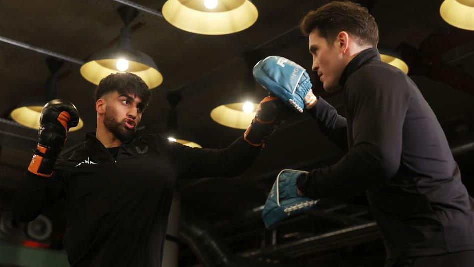 Adam Azim on the pads with trainer Shane McGuigan