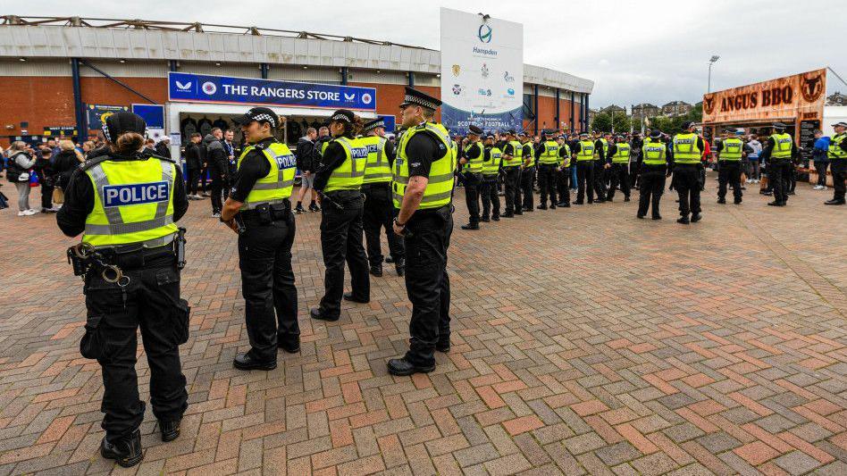 Police formed a line outside the national stadium to separate supporters before kick-off