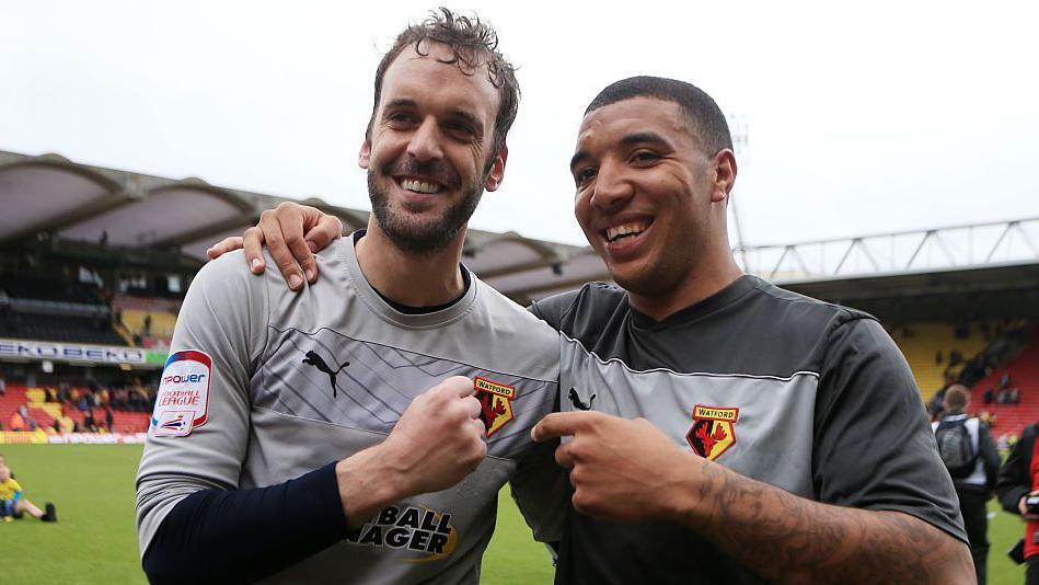 Manuel Almunia and Troy Deeney embrace after the late drama at Vicarage Road in 2013