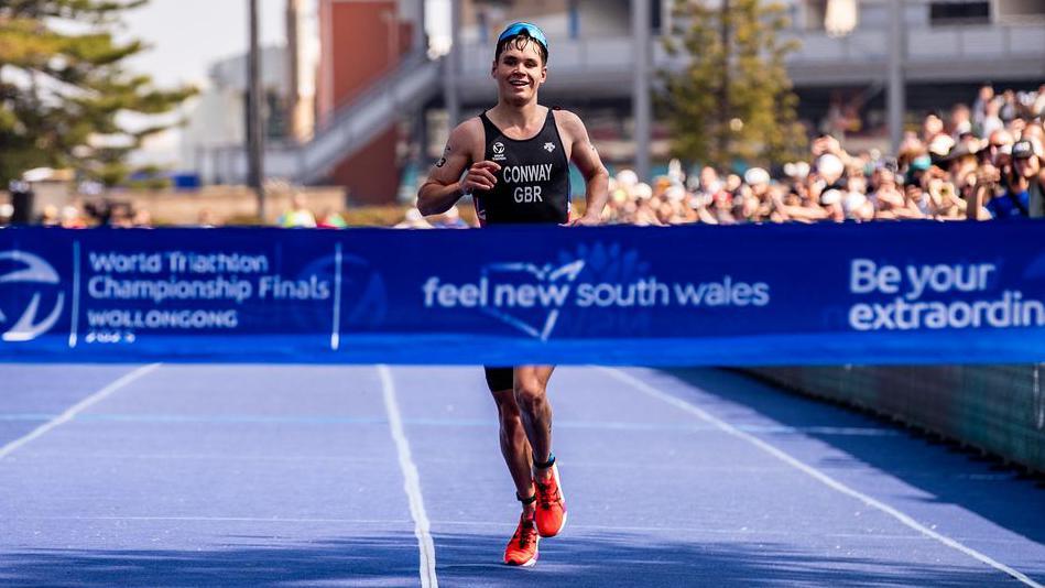 Great Britain's Oliver Conway crossing the finish line in first