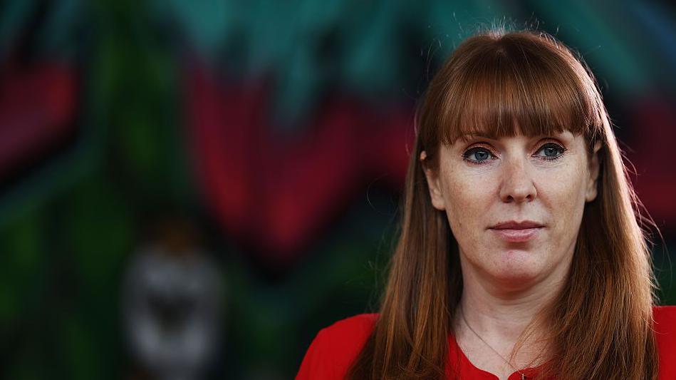 Angela Rayner wearing a red top looking slightly off camera