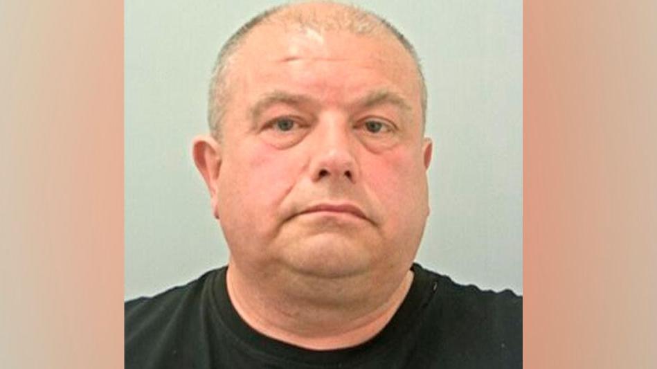 Craig Hodgson mugshot. He has short, thinning grey hair and a black t-shirt.