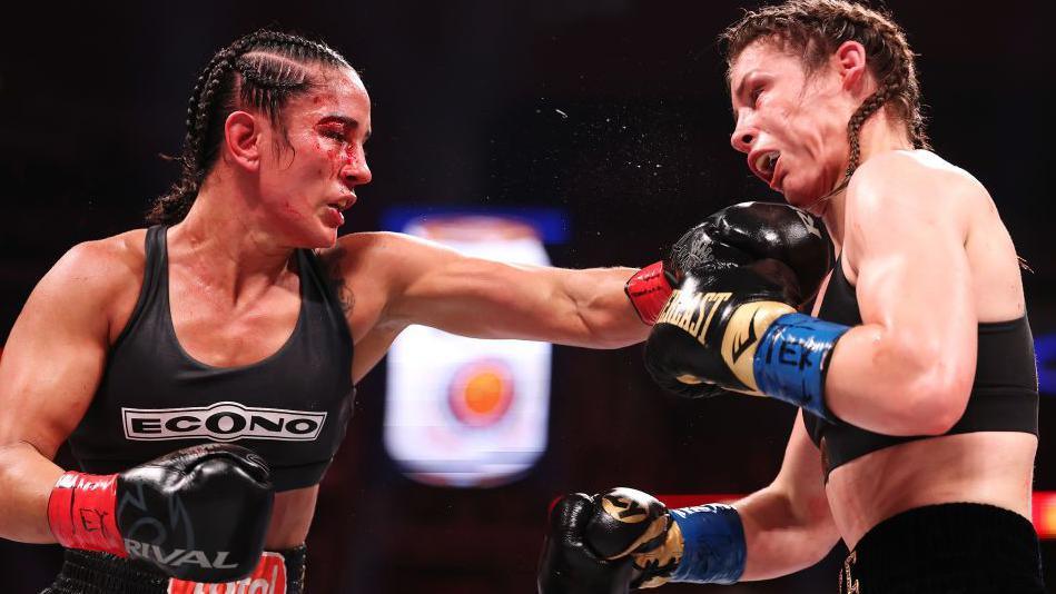 Amanda Serrano lands a heavy punch on Katie Taylor