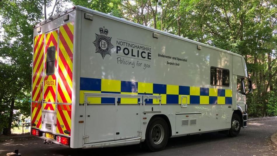 A Nottinghamshire Police lorry from the police underwater search team at the lake near Cambridge