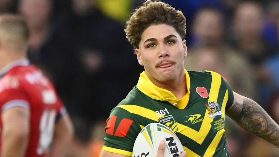 Reece Walsh gallops toward the posts with ball under his arm for Australia after outpacing the England defence