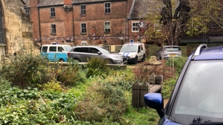 Cars parked next to the church