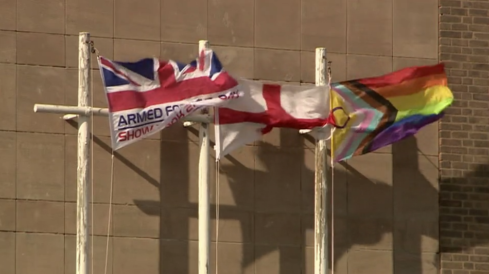 Image showing flags flying outside Shire Hall in Warwickshire including the Armed Forces Flag, the St George's Cross and the Pride Progress Flag.