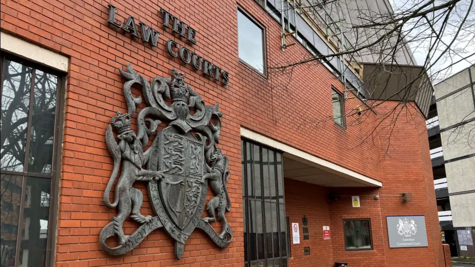 An exterior shot of Swindon Crown Court , a red brick building with a crest and sign which reads 'Swindon Combined Courts'