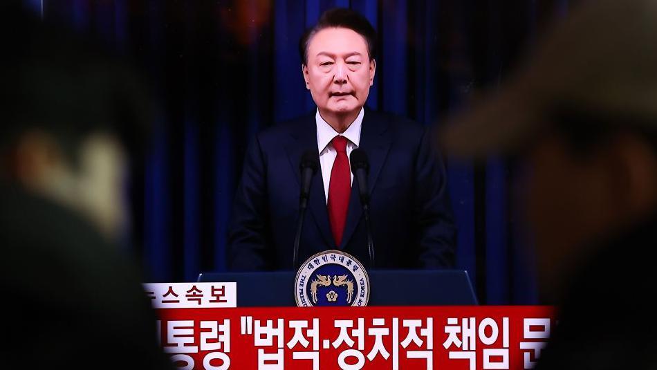 A screens shows footage of South Korean President Yoon Suk Yeol delivering an address to the nation at Seoul station on December 07, 2024 in Seoul, South Korea.