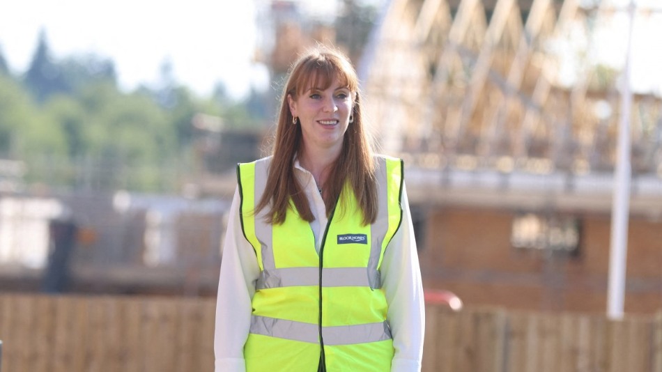 Deputy Prime Minister Angela Rayner visits a housing development site in Basingstoke while wearing a white shirt and a yellow hi vis jacket