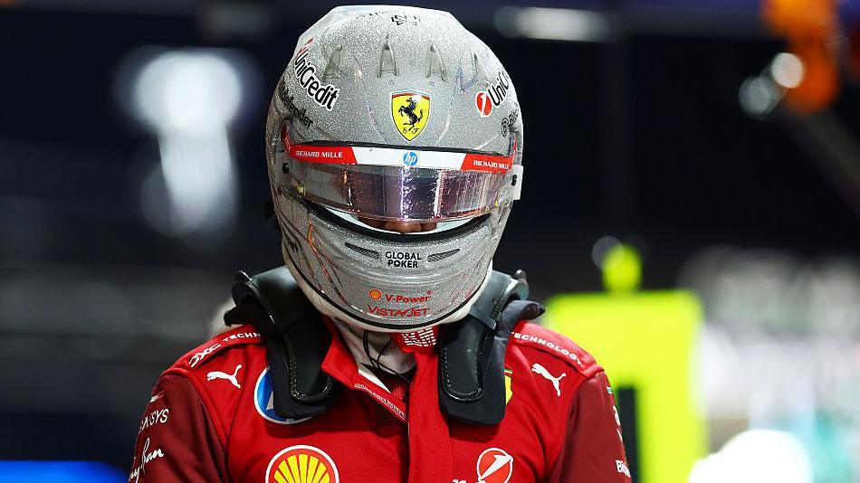 Lewis Hamilton, still wearing his race helmet, after getting out of his Ferrari having been eliminated in the first part of qualifying