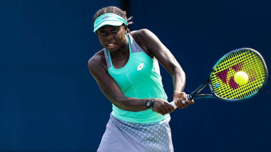 Angella Okutoyi hits a double-handed backhand