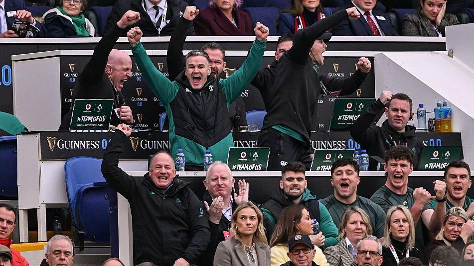 Ireland's coaching staff celebrate their side winning a penalty