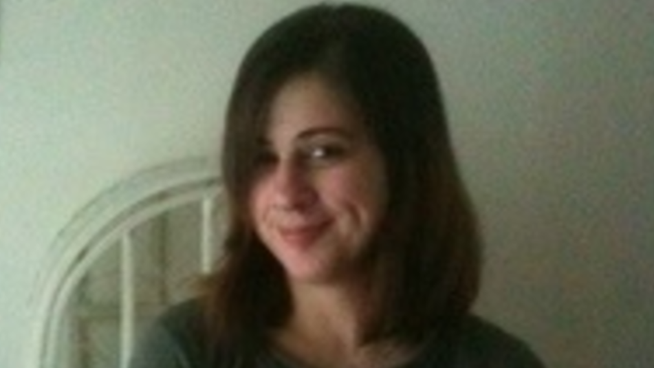 A picture of Rachael Vaughan, who is smiling at the camera. She has long brown hair and is wearing a green shirt.