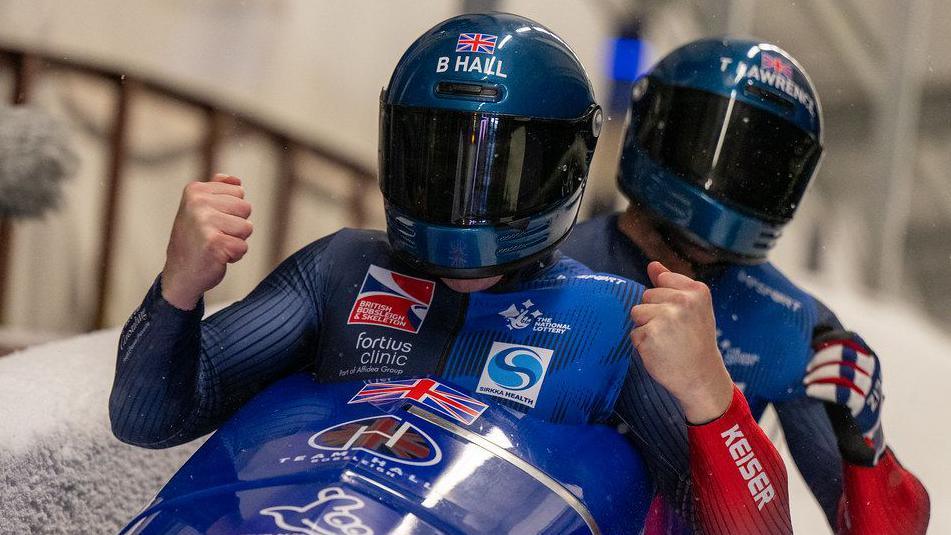 British bobsleigh duo Brad Hall and Taylor Lawrence celebrate at the end of their run