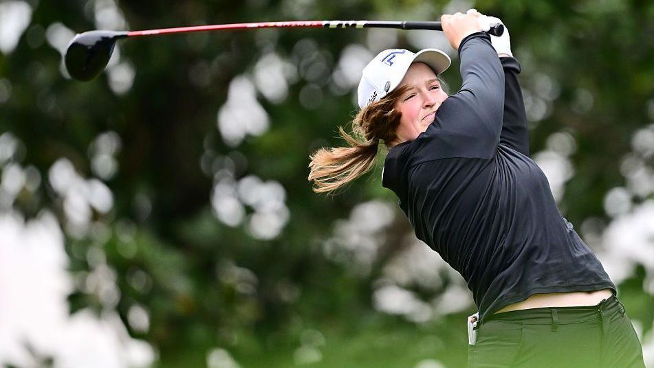 Lottie Woad swings a golf club