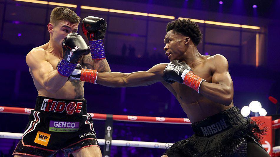 Abdullah Mason throws a left to the body