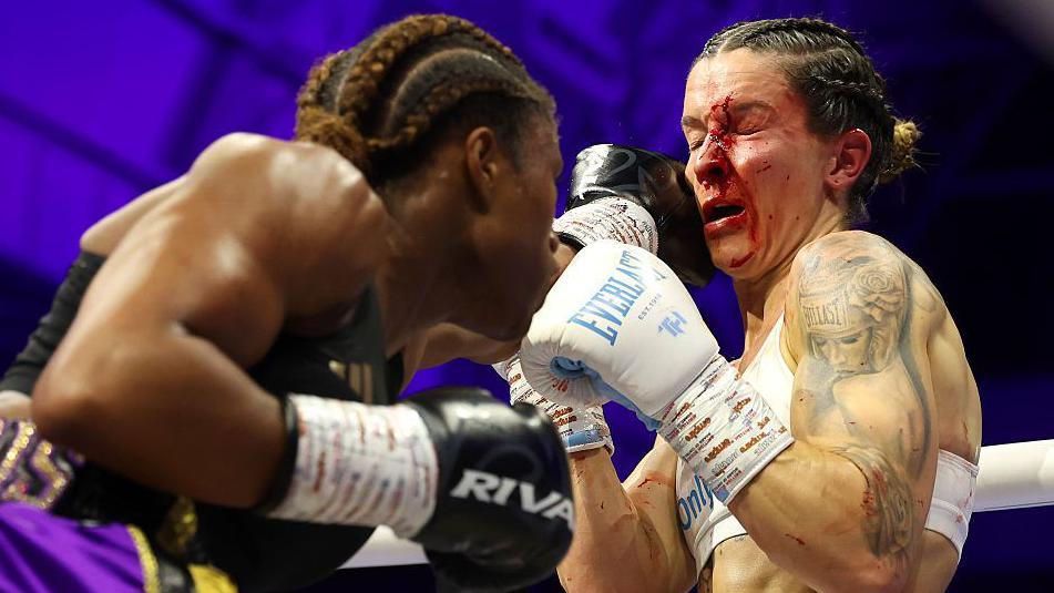 Caroline Dubois lands a punch on Terri Harper whose face is already smeared in blood