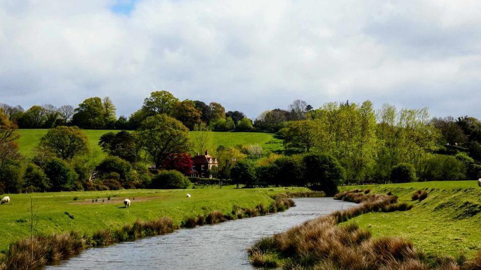 A river running through a field near Rye