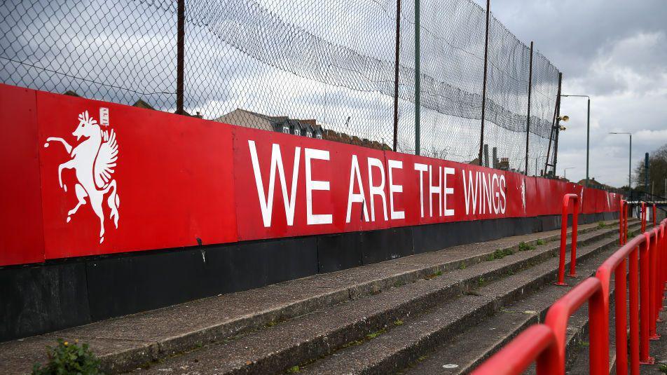 A red sign at Park View Road that says 'we are the wings'