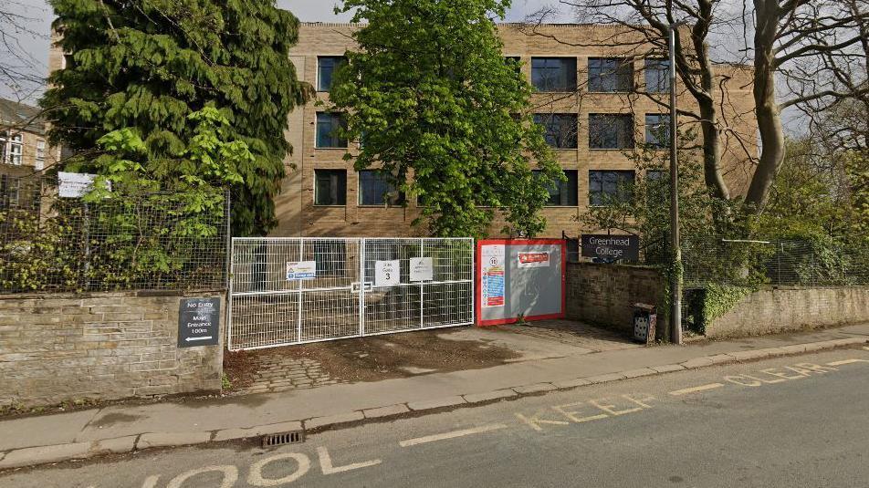 Greenhead sixth form college in Huddersfield.  It has a building site-style gate across the entrance. 